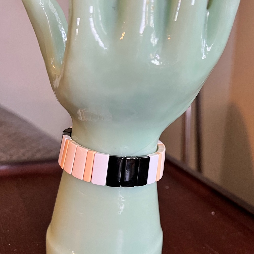 Roxanne Assoulin enamel tan, white, black and gold elastic bracelet.